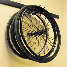 An extra set of wheelchair wheels hanging on a wall